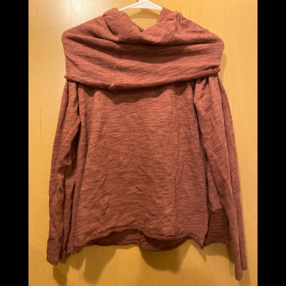 Free people sweater color is burgundy sizes extra small worn ones